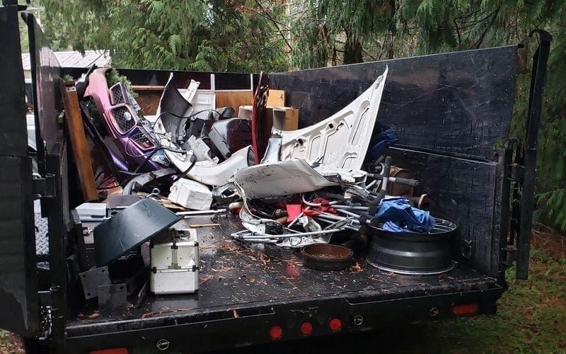 The cluttered back of a truck packed with diverse junk for efficient trash removal in WA.
