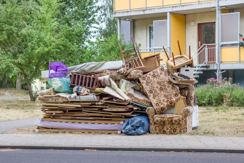 A pile of furniture sitting on top of the ground.